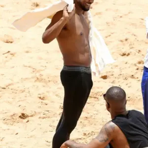 Usher revealing bulge on beach